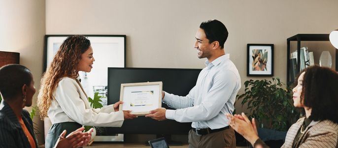 Header Image of a young female business woman receiving a certification